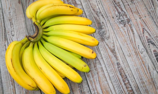 Fresh bananas on wooden table