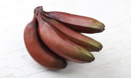 Red banana heap on the wood background