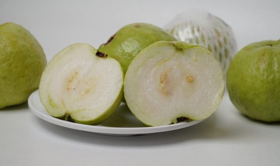 sliced-ripe-fresh-crystal-guava-white-plate-white-background